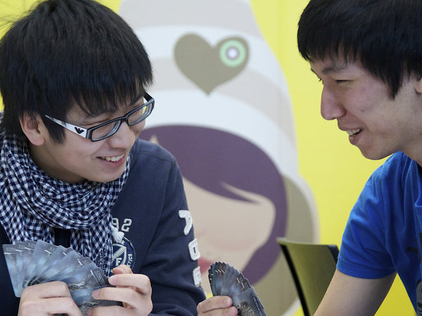 Two students playing cards