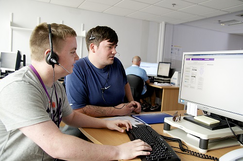 2 students studying together at a workstation