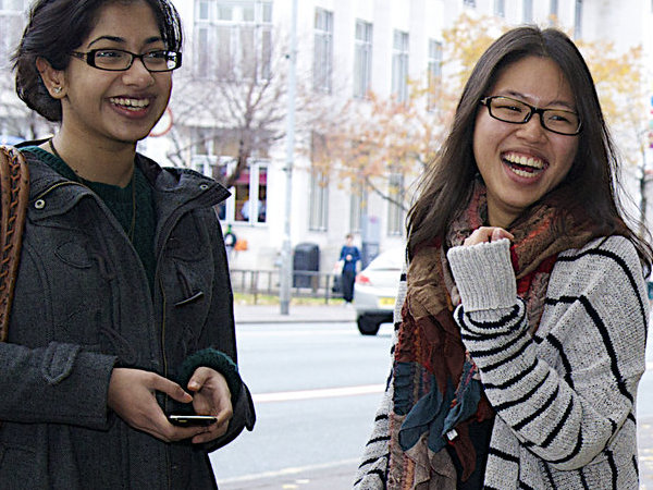 Two students laughing outside